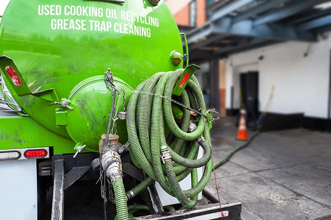 a vacuum truck pumping out a large underground grease trap in Aptos